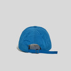 Adjustable baseball cap in blue and pale yellow, rear view showing the open back and metal slider strap