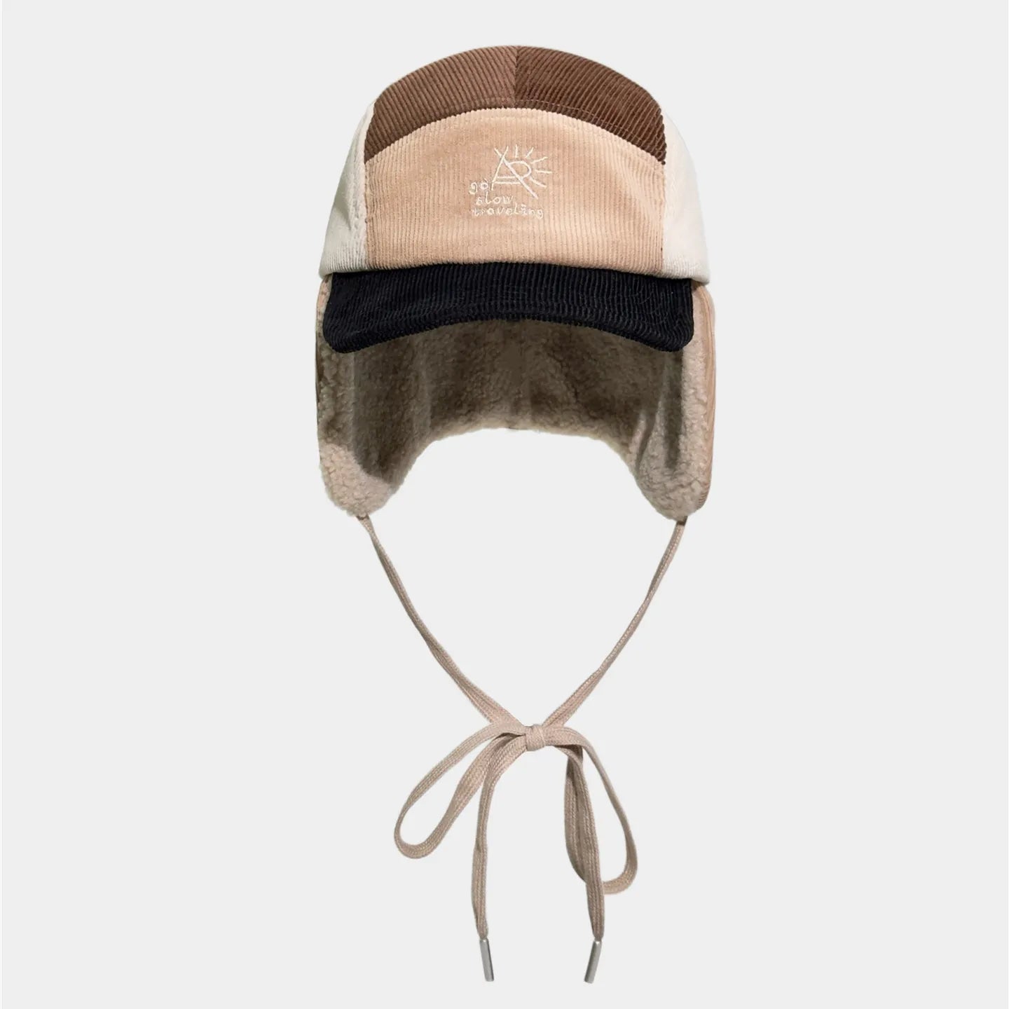 Adjustable corduroy trapper hat with ear flaps, chin strap and versatile winter styling
