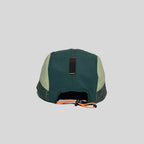 Adjustable five panel cap in forest green and cream, rear view with an orange toggle cord and black webbing tab