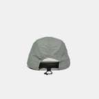 Adjustable nylon cap in light grey, rear view showing the open back, stitched panels and bungee toggle