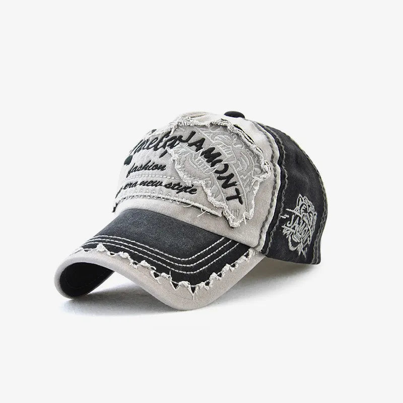 Black and grey distressed baseball cap with a tiger embroidery patch, frayed brim and contrast stitching