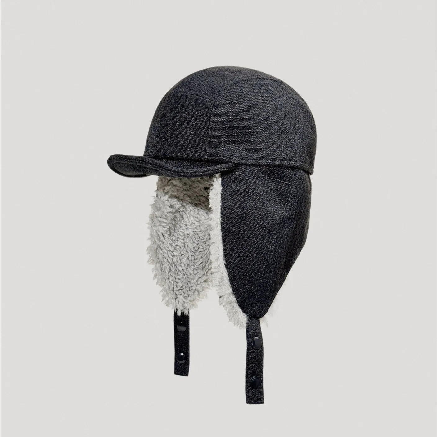 Black sherpa lined aviator cap with warm fleece ear flaps for outdoor winter wear