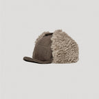 Brown aviator cap side profile with fleece ear flaps and cotton linen outer texture