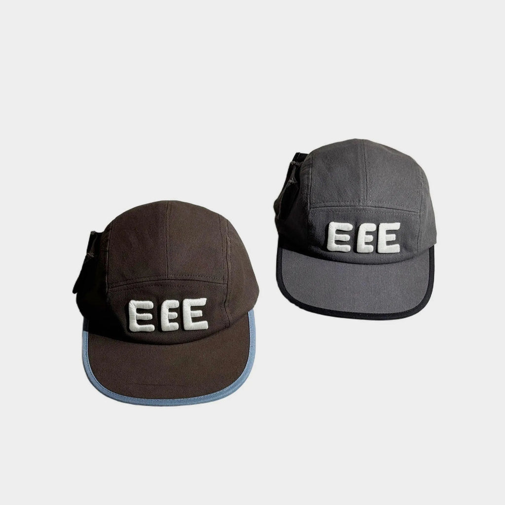 Front view of brown and grey five-panel caps with raised white EEE embroidery, flat brims and contrasting edge trim.
