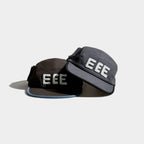 Brown and grey five-panel caps displayed together with raised white EEE embroidery, contrast brim trim and black side bow details.