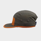 Side view of a brown and orange five-panel cap featuring contrast trim, panel stitching and two embroidered ventilation eyelets.
