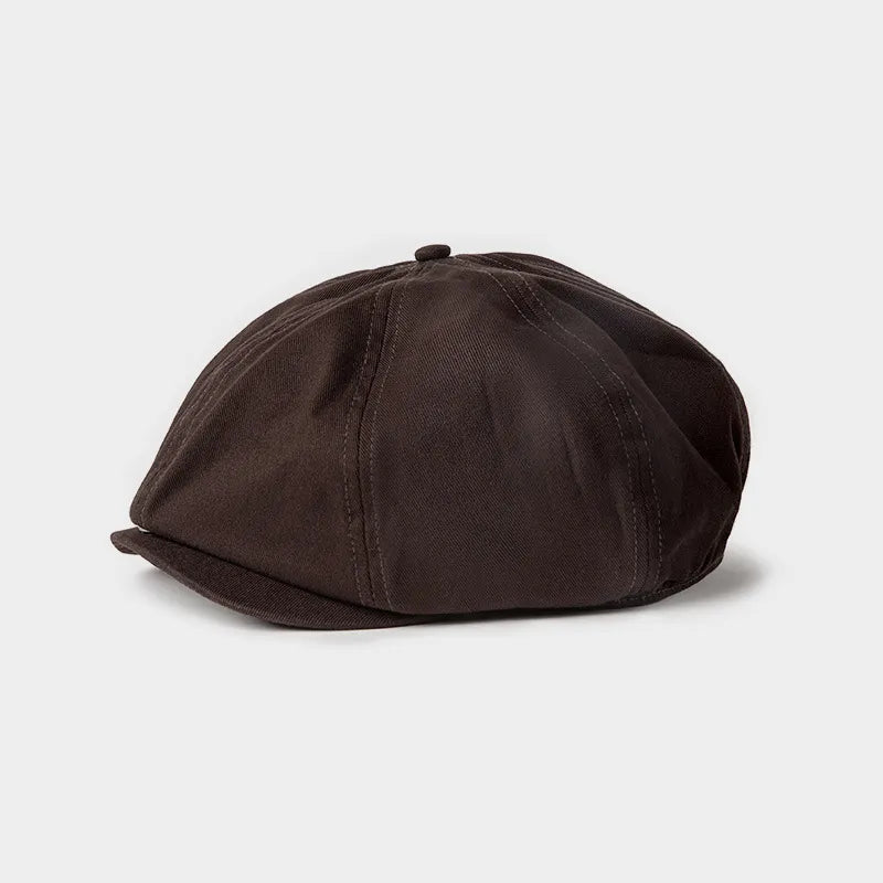Brown waxed newsboy cap featuring traditional eight panel construction