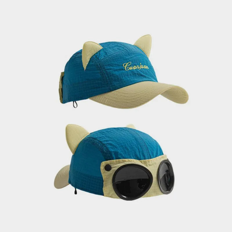 Teal blue cat ear baseball cap with pale yellow accents, shown from the curved brim and decorative goggle sides.