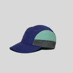 Drawcord camper cap in deep purple and mint green, profile view highlighting the orange toggle and checked lower panel