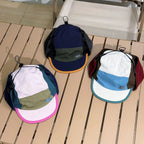 Lightweight nylon trapper hat with colour block panels and adjustable cord system