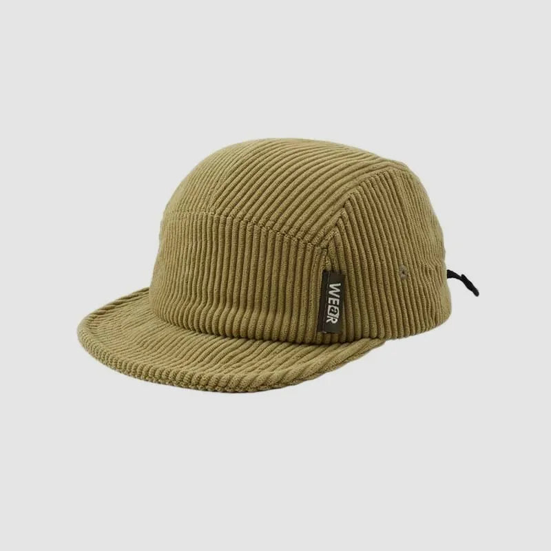 Olive green cotton corduroy cap angled from the front with a short brim and an easy casual look.