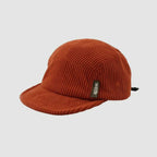 Rust orange cotton corduroy 5-panel cap shown at an angle with a low-profile crown and curved short brim.