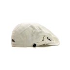 Cotton flat cap in off-white, side view with a short peak, embroidered lettering and snap-tab adjustment