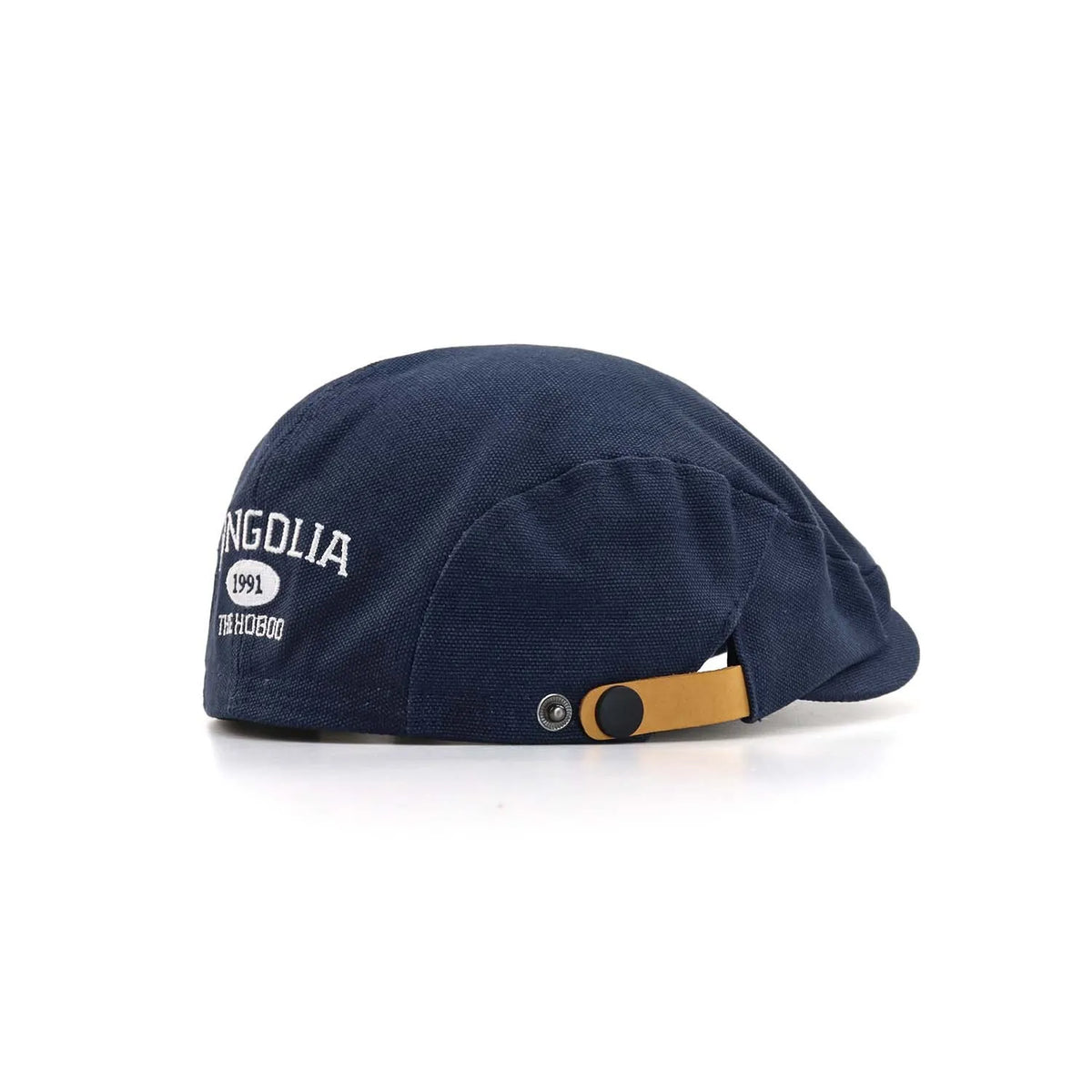 Embroidered cotton ivy cap in navy, angled from the rear with MONGOLIA 1991 lettering and a tan press-stud tab
