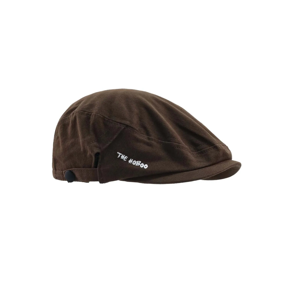 Duckbill flat cap in dark brown, side profile showing the close-fitting crown, short peak and letter embroidery