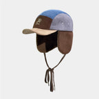 Embroidered corduroy trapper hat featuring colour block panels and retro outdoor aesthetic