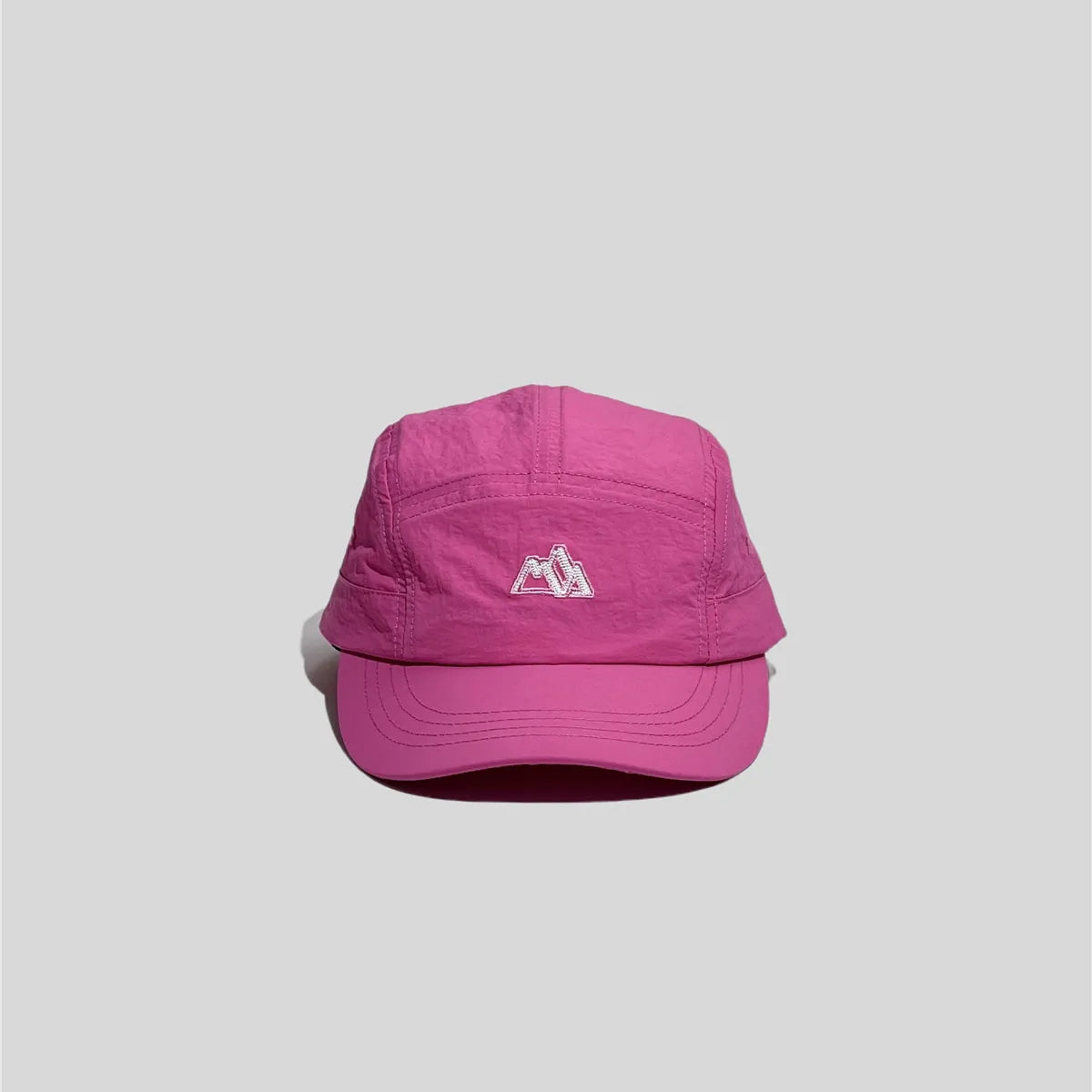 Embroidered five panel cap in magenta pink, front view with mountain logo and curved stitched brim