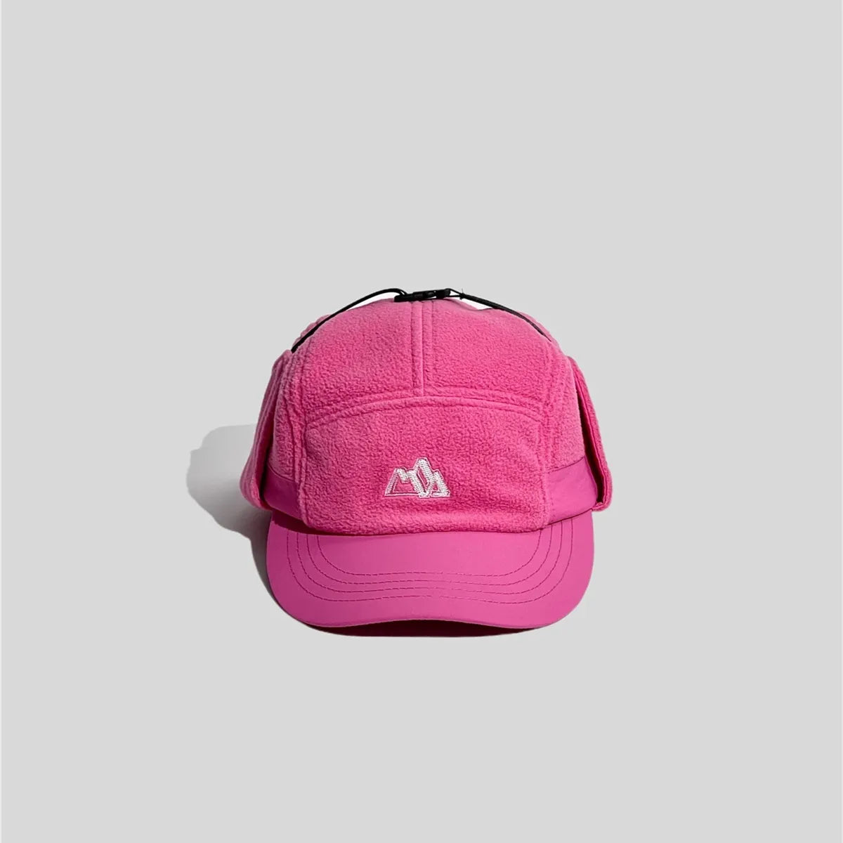 Fleece ear flap cap in bright pink, front view with a curved peak and mountain embroidery