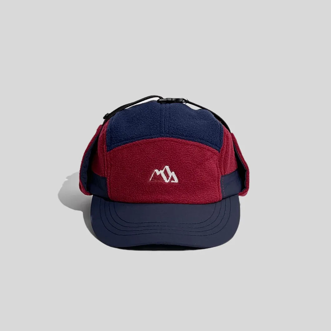Fleece ear flap cap in navy and burgundy, front view with a curved peak and mountain embroidery