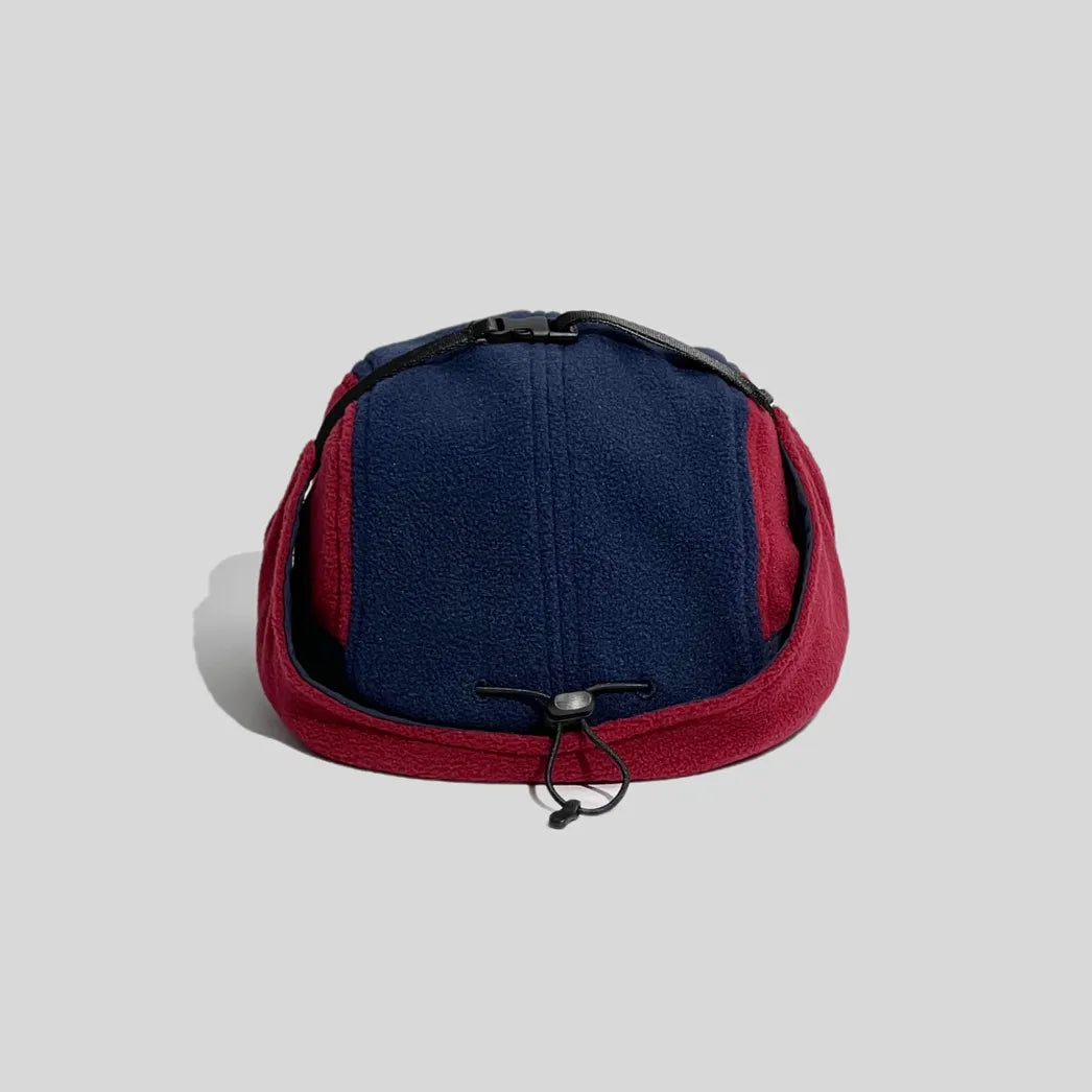 Fleece winter cap in navy and burgundy, rear view with a wraparound ear flap, crown strap and toggle drawcord