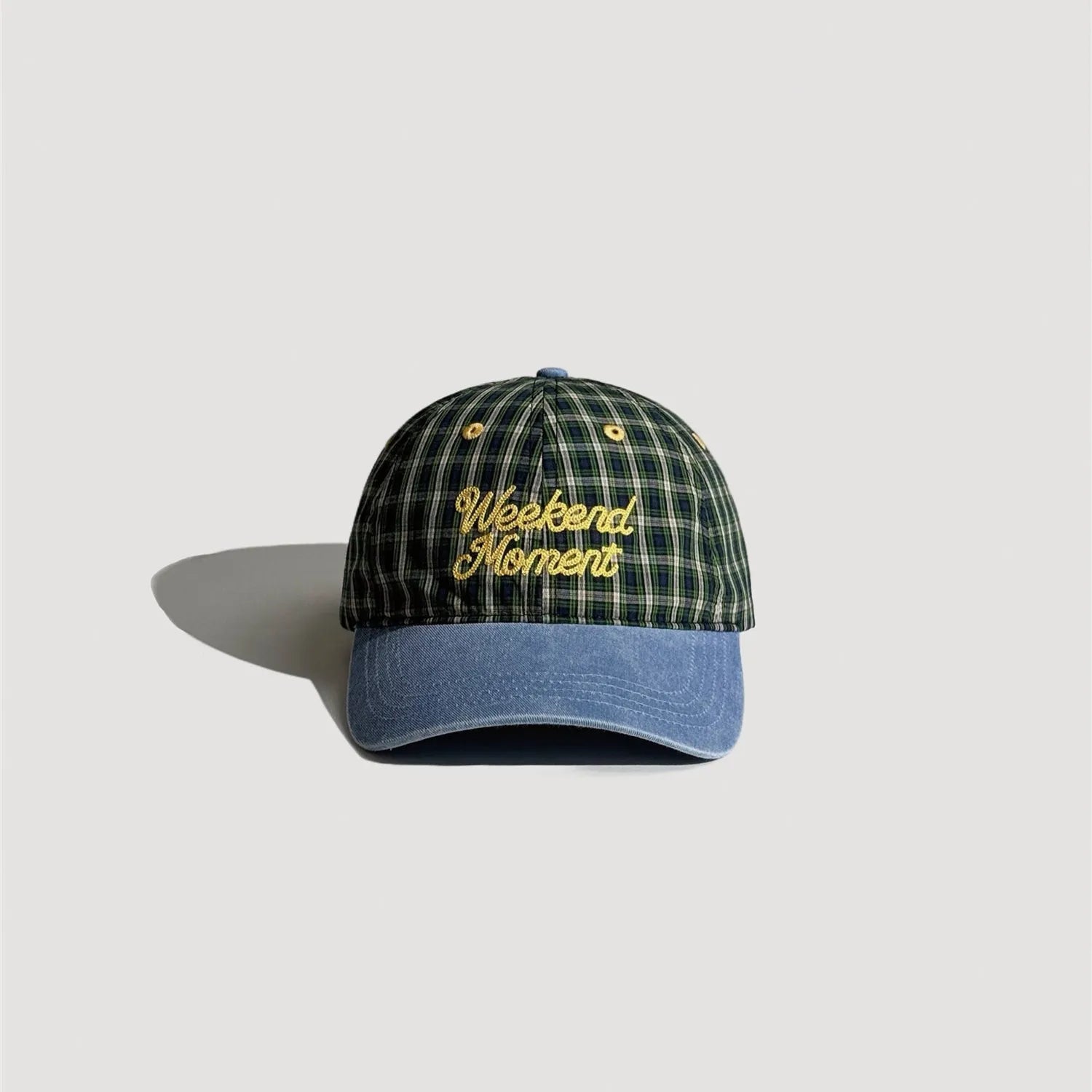 Green plaid 5 panel cap with embroidered lettering and denim style curved brim