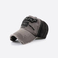 Grey and black vintage baseball cap with embroidered lettering, curved brim and distressed frayed edges