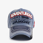 Front view of a grey-blue vintage baseball cap with raised embroidered lettering, contrast stitching and a curved brim