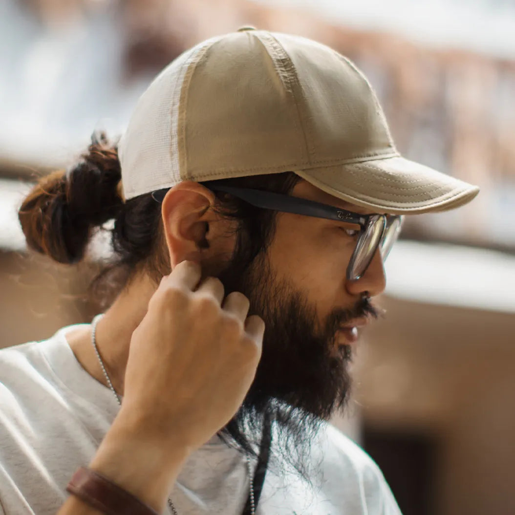 Nylon cap with curved brim stitching detail and minimalist embroidered logo