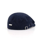 Herringbone flat cap in navy, rear angle with a silver nameplate, short peak and adjustable metal buckle