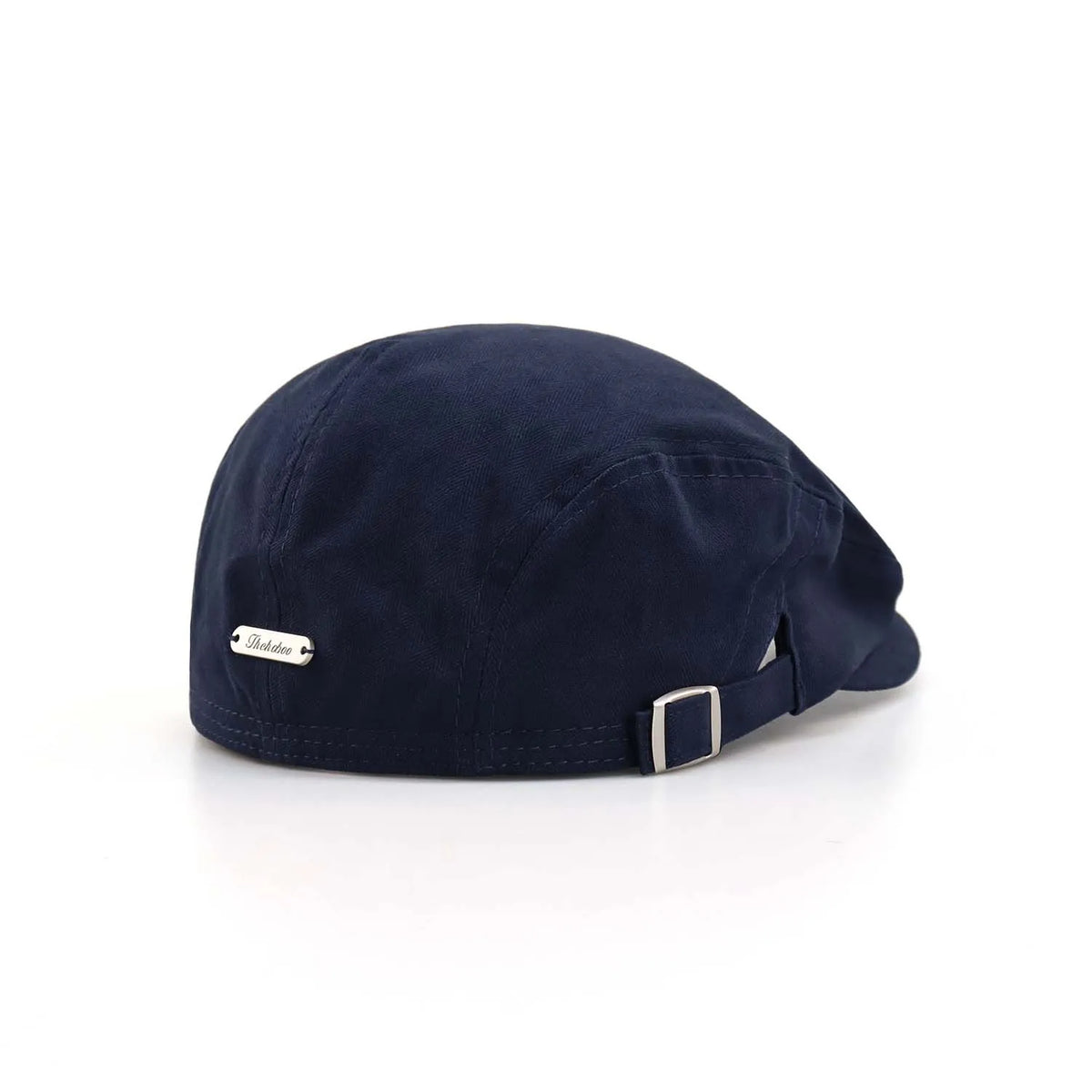 Herringbone flat cap in navy, rear angle with a silver nameplate, short peak and adjustable metal buckle