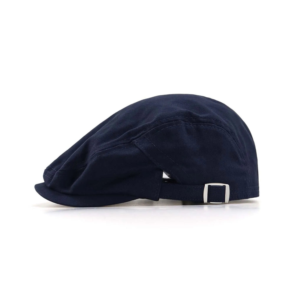 Herringbone flat cap in navy, side profile with a close-fitting crown, short peak and rectangular metal buckle