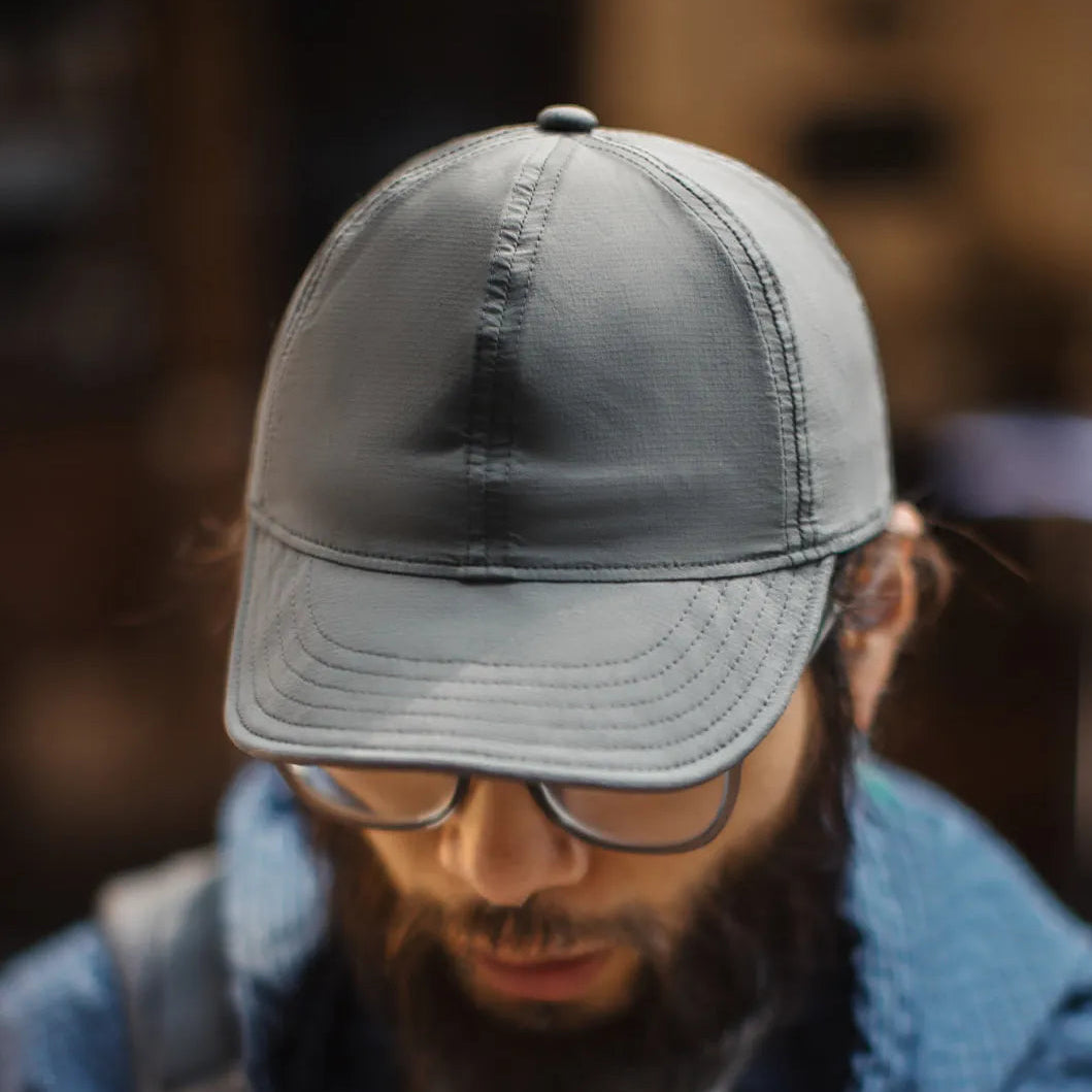 Grey nylon outdoor cap with lightweight structure and modern casual styling