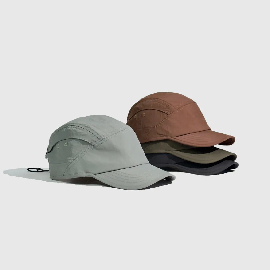 Lightweight nylon caps displayed in black, khaki green, light grey and rust brown colourways