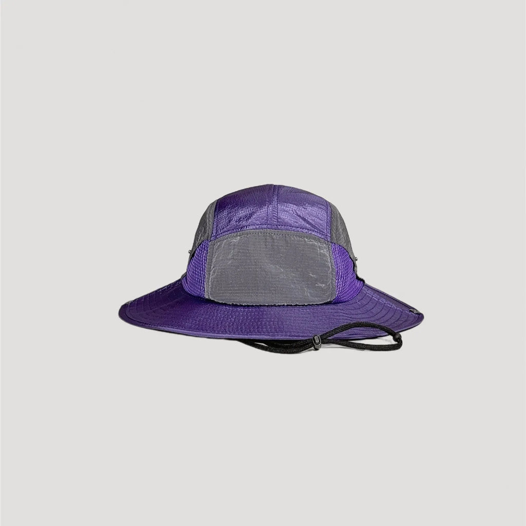 Purple nylon outdoor bucket hat with wide brim silhouette and technical design details