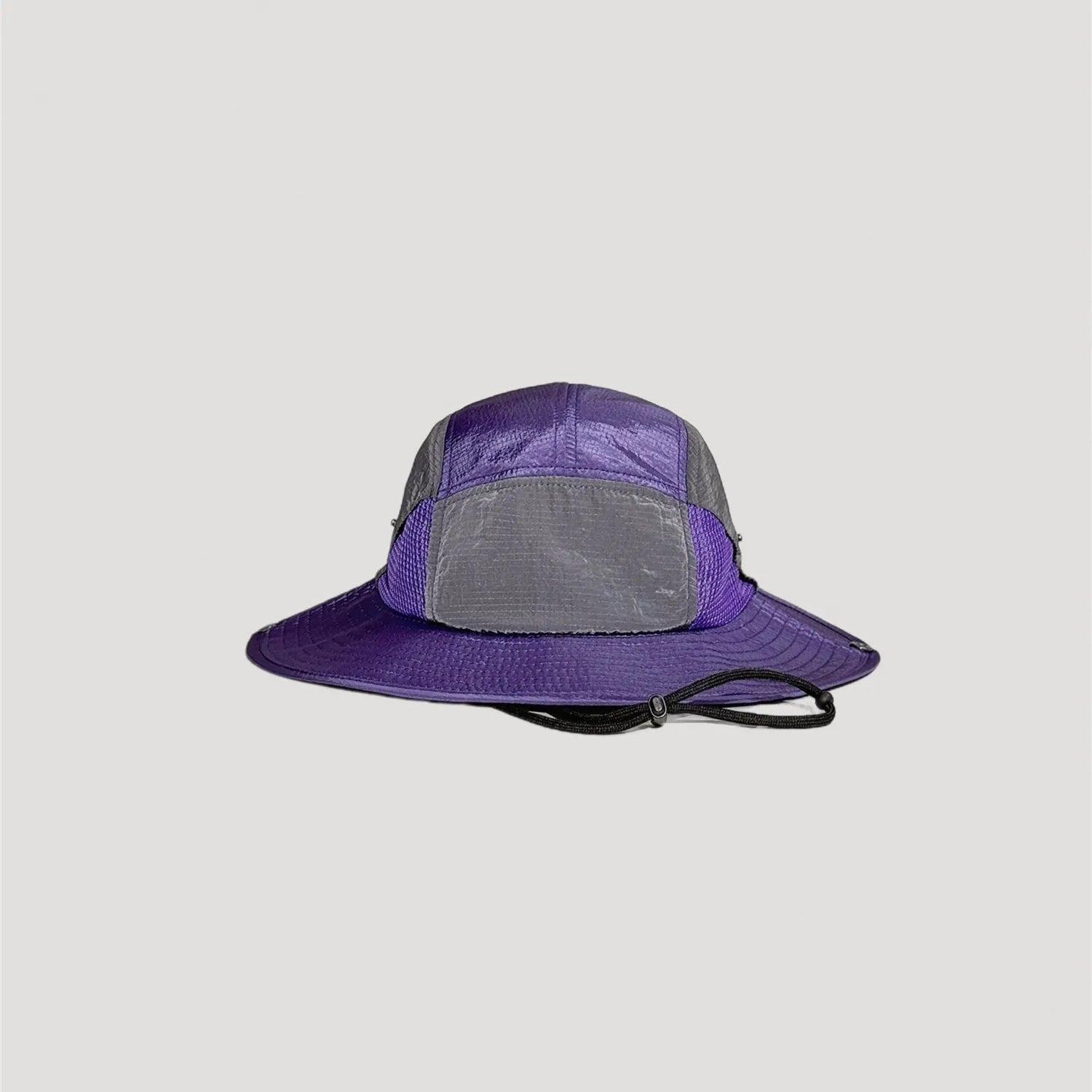 Purple nylon outdoor bucket hat with wide brim silhouette and technical design details