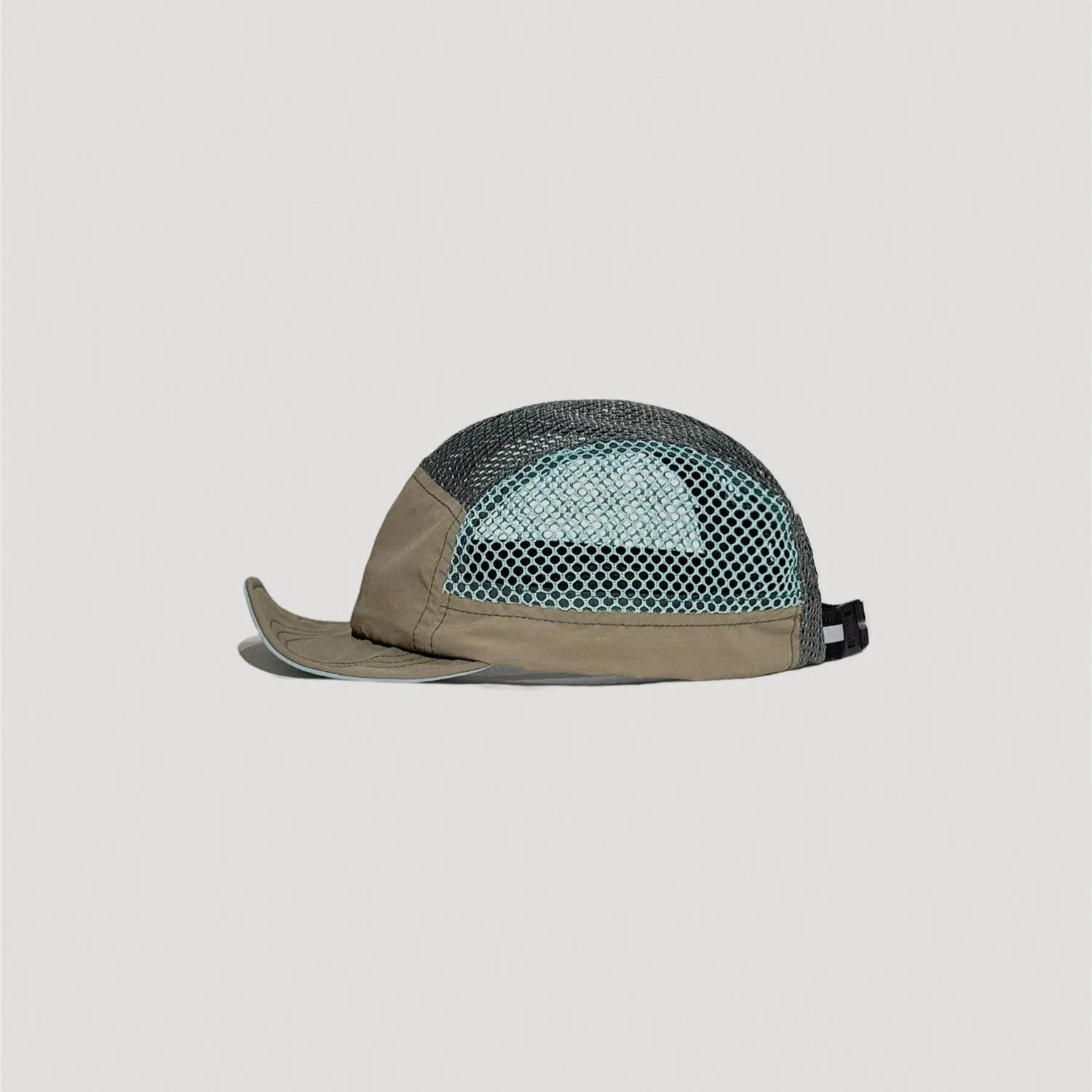 Low profile nylon outdoor cap side view with curved brim and mesh ventilation panels
