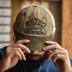 Man wearing a khaki retro fish embroidered baseball cap with a contrasting corduroy curved brim