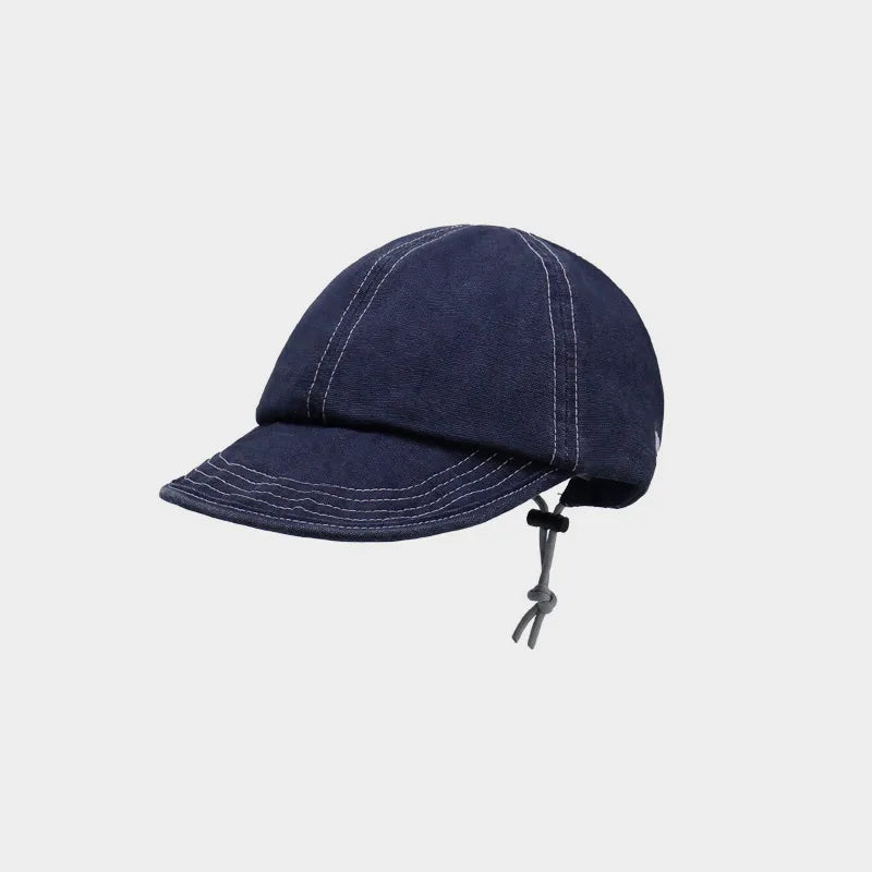 Navy cotton short brim cap with contrast stitching and an adjustable rear drawcord