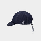 Side view of a navy cotton short brim cap with small white embroidery and rear drawcord adjustment