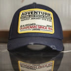 Front view of a navy cotton baseball cap with an Adventure patch and curved brim