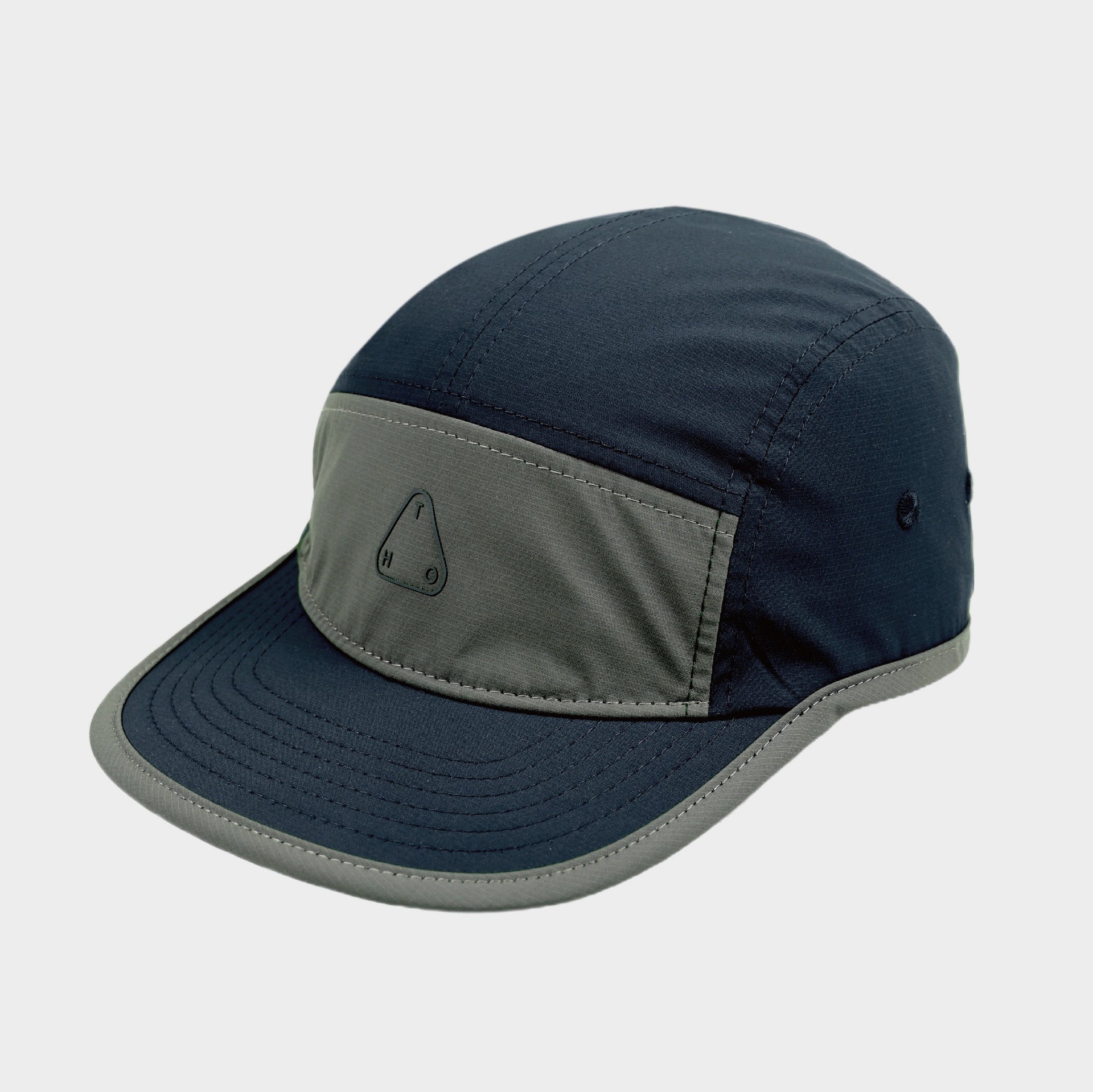 Navy and grey colour-block five-panel cap with a flat stitched brim, contrast edging and small triangular front logo.
