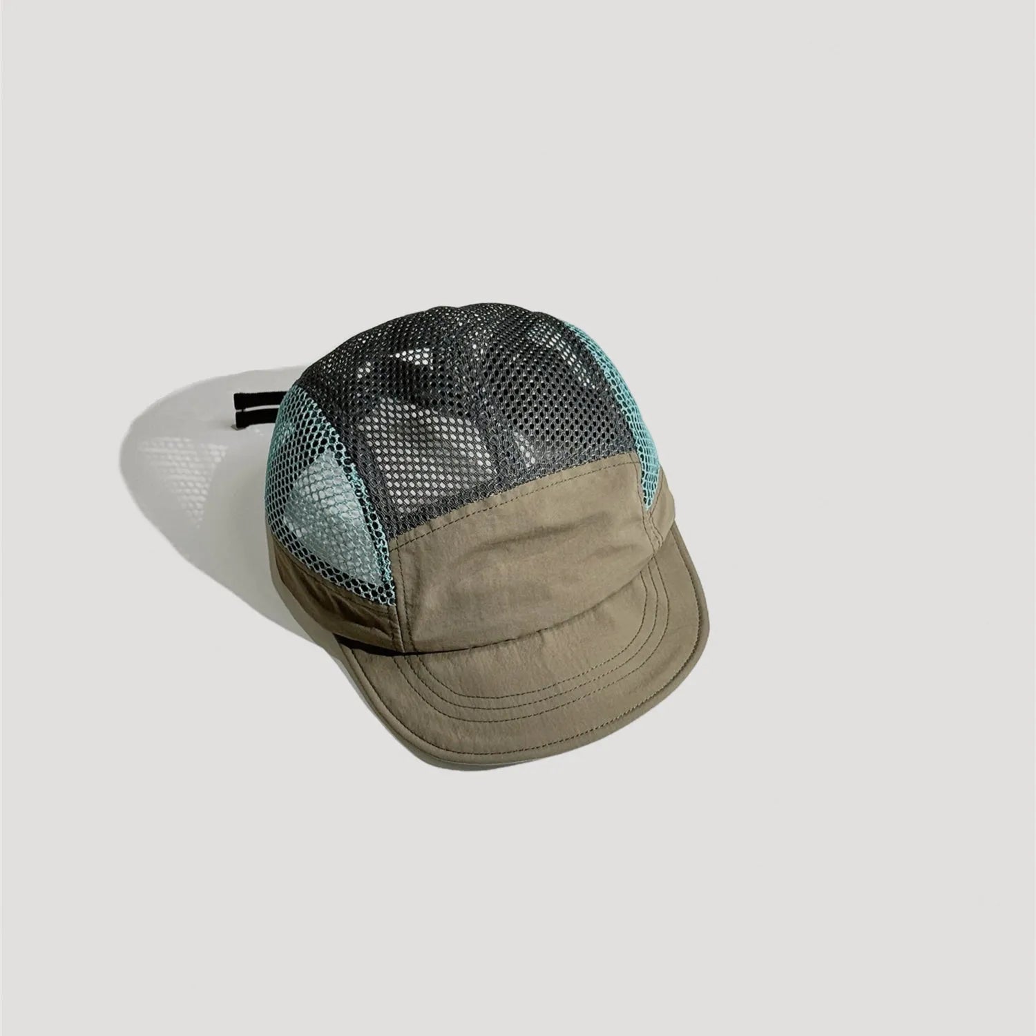 Khaki and black nylon 5 panel cap with breathable mesh panels and curved brim design