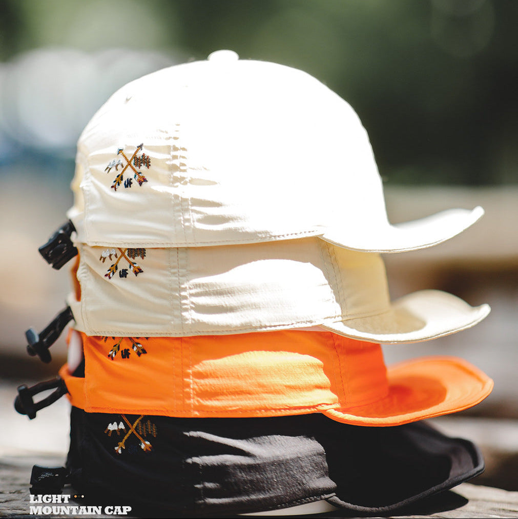 Beige, orange and black nylon baseball caps displayed together with curved brims and small side embroidery
