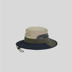 Nylon safari hat in left side profile, with grey mesh panels, a navy and olive brim and adjustable chin cord.