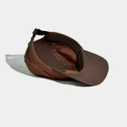 Nylon camper cap interior in dark brown, burnt orange and chestnut, showing the sweatband, bound seams and eyelets