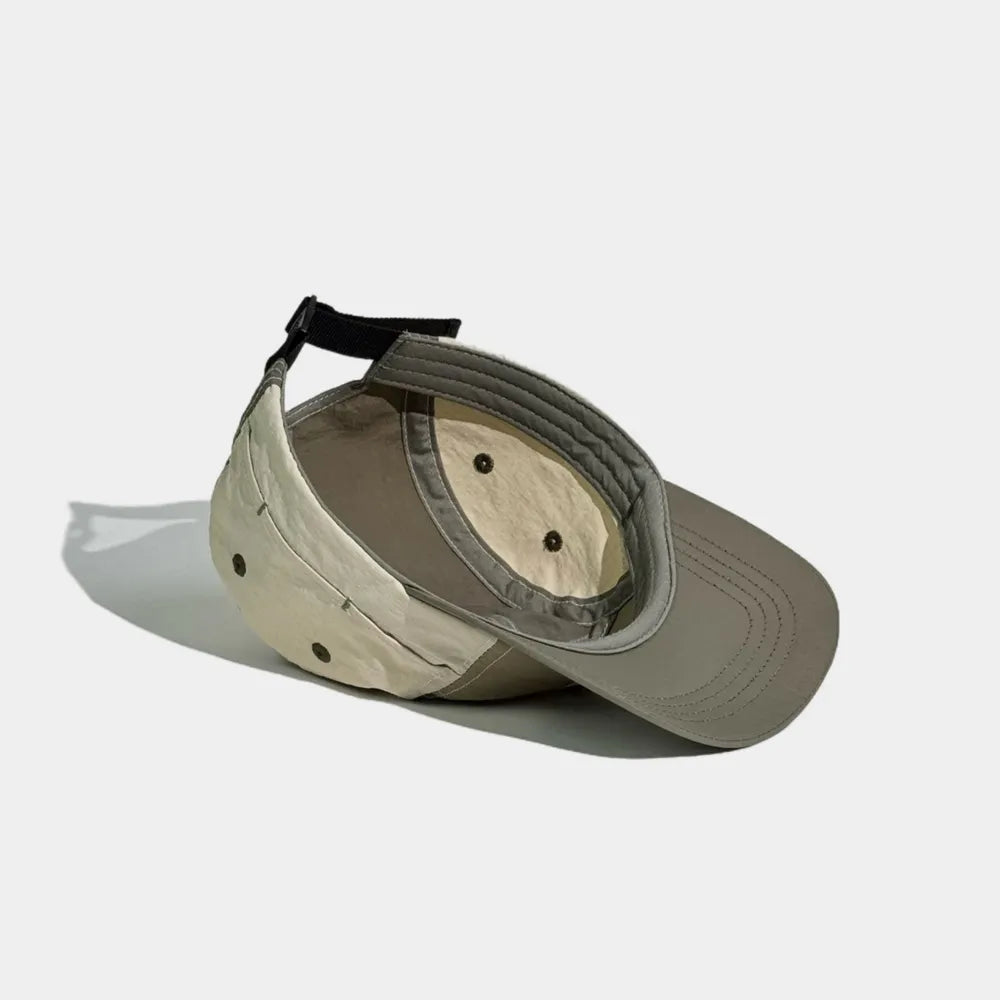Nylon camper cap interior in olive grey, khaki and cream, showing the sweatband, bound seams and eyelets