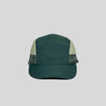 Nylon five panel cap in forest green and cream, front view with a curved stitched peak and fine grid side panels