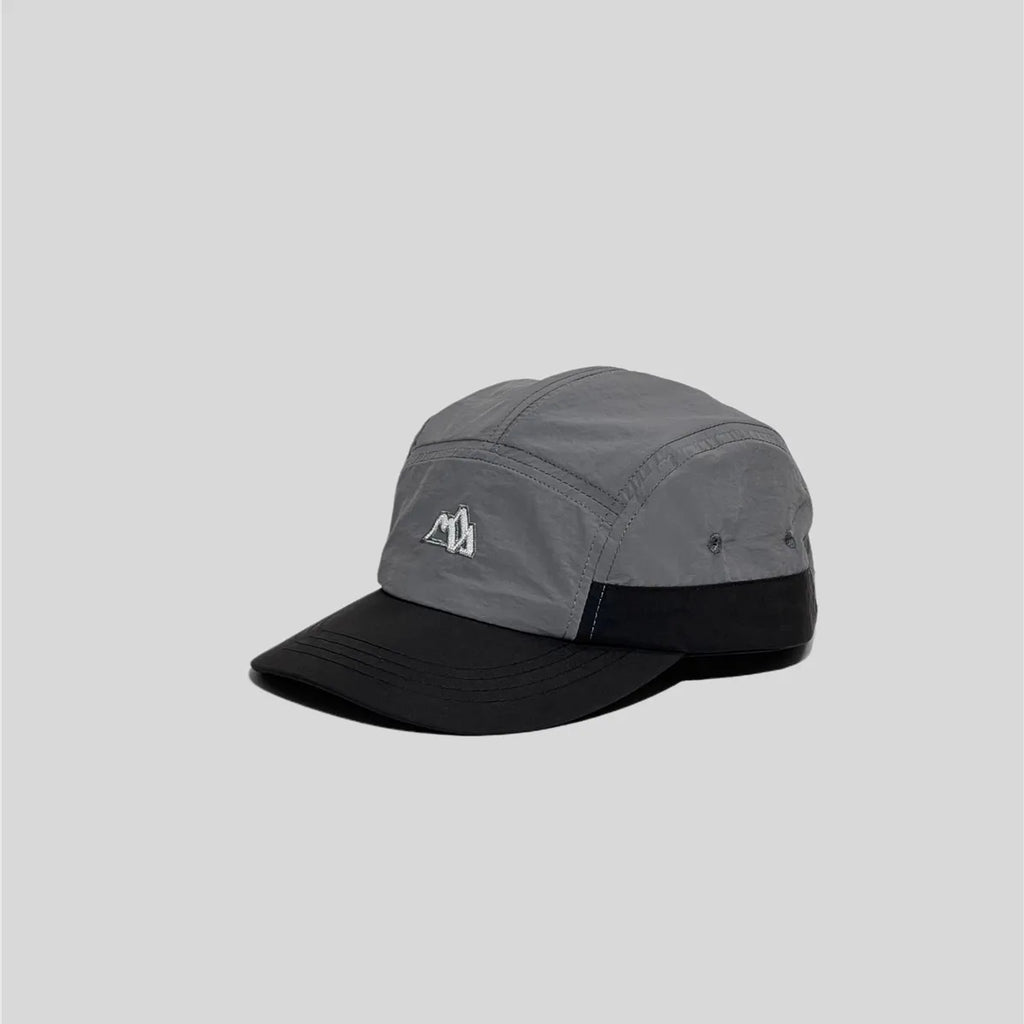 Nylon five panel cap in grey and black, angled view with curved brim, eyelets and mountain embroidery