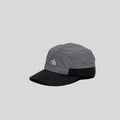 Nylon five panel cap in grey and black, angled view with curved brim, eyelets and mountain embroidery