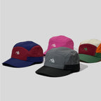 Nylon five panel caps arranged in magenta pink, retro multicolour, navy-burgundy and grey-black colourways